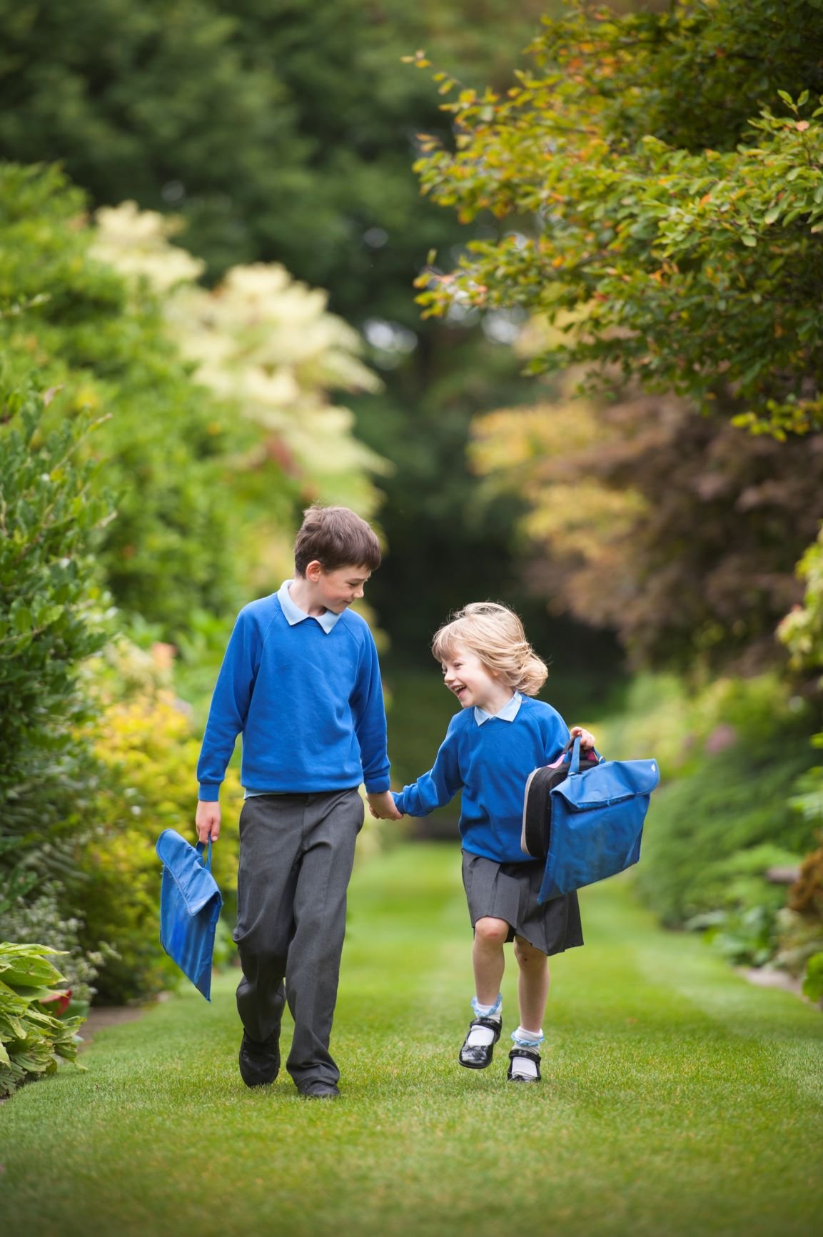 Back to school photo - brother and sister walking to school